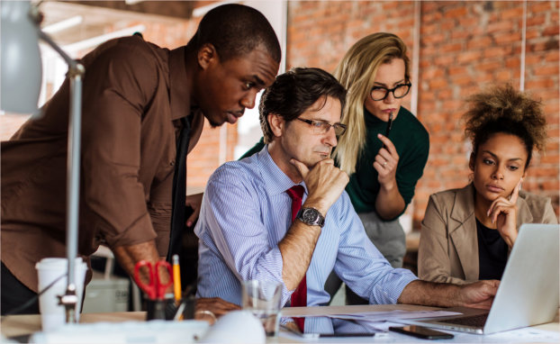 team looking at a laptop