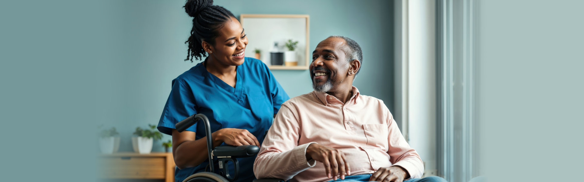 Happy caregiver with a smiling eldery man in a wheelchair at home