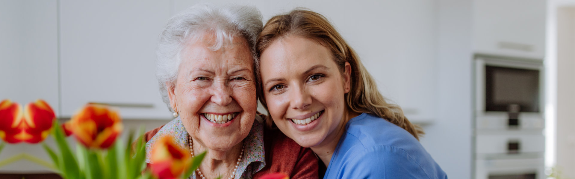 a nurse and an elder smiling