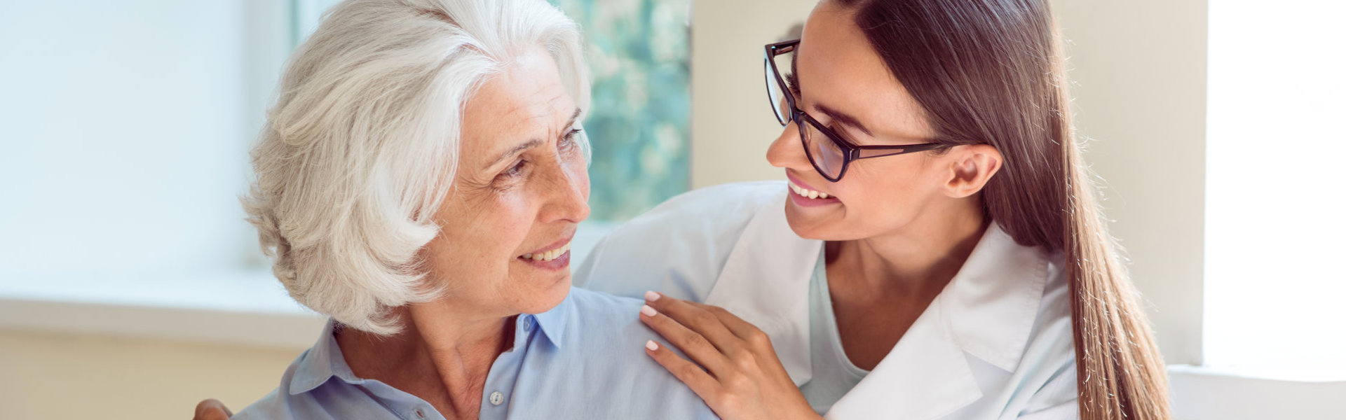 a woman and an elderly woman looking at each other