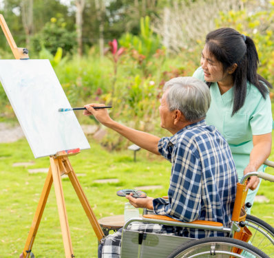 Side view of Asian nurse stand beside senior man sit on wheelchair