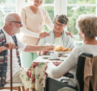 Happy seniors having a cake in a nursing home