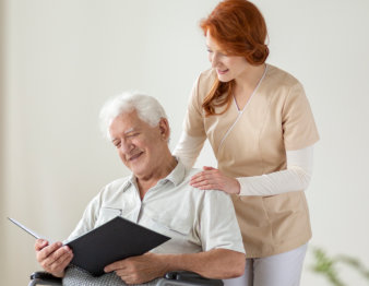 caregiver and elderly man smiling