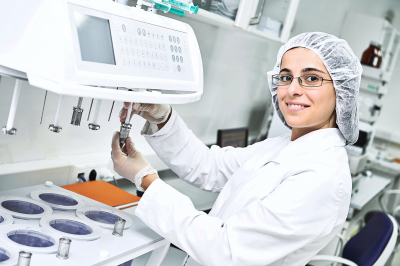 pharmaceutical scientific female researcher in protective uniform