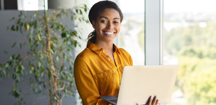woman holding laptop smiling