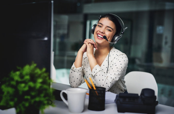 woman smiling while wearing headset