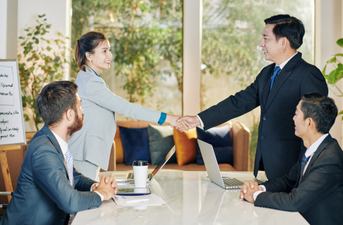 man and woman having a handshake