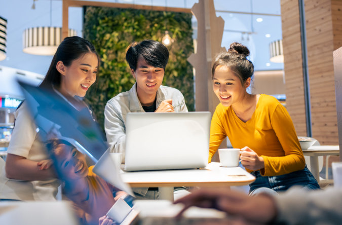 three people looking at the laptop