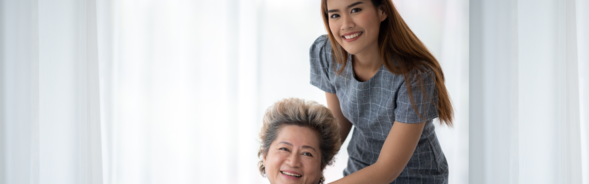 Female caregiver and elder woman are happy